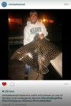 Photo of Wenzel holding a Spotted eagle ray he illegally killed which is a protected species