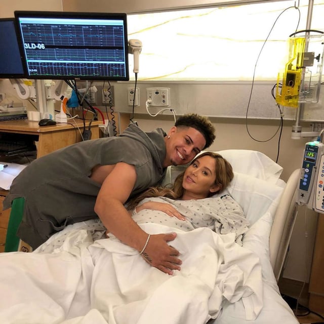 Austin McBroom hugging his wife Catherine after she gave birth to their third child