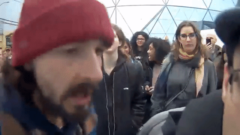 Shia chants at the top of his lungs "HE WILL NOT DIVIDE US" to a Trump supporter attempting to ridicule the crowd.