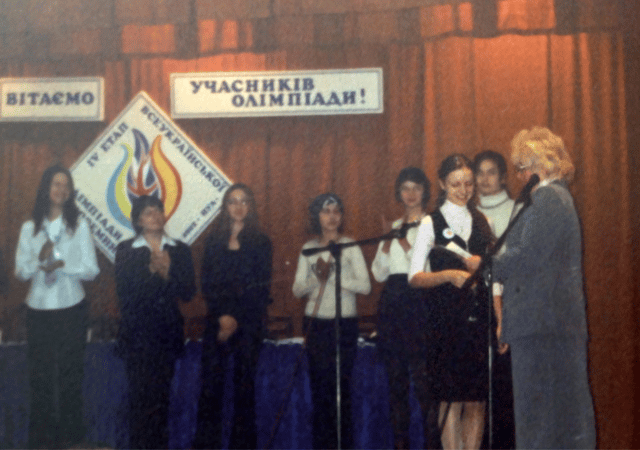 Photo of when she received a certificate for graduating from an advanced class in the English language.