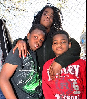 Angela Small with her two sons Terell and Marsean at the location where Robert Godwin, Sr. was killed