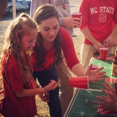 Cheyanne teaching her sister Mollie how to play Flip cup