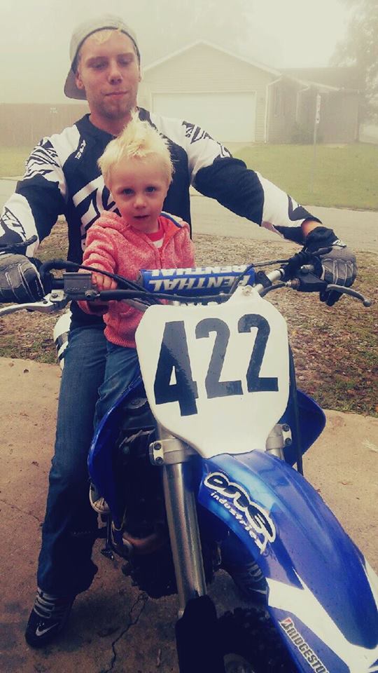 Travis and his son on his bike