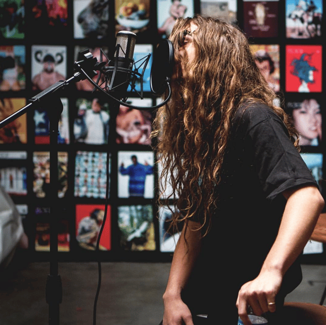 Yung Pinch in the studio singing in the booth.