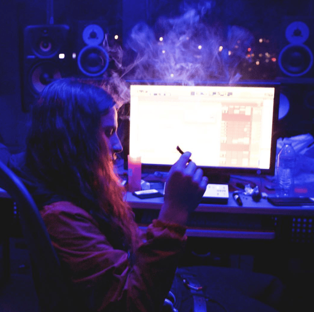Yung Pinch inside of the studio smoking Cannabis.