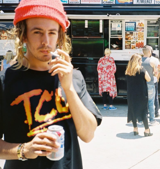 Brandon enjoying a cigarette and a PBR next to a food truck