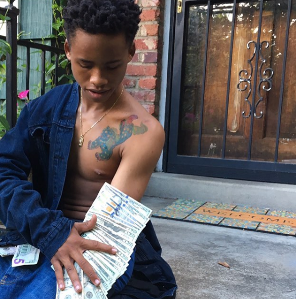 TAY-K counting money on his arm