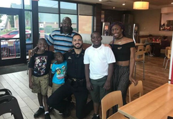 Photo of Matthew Baxter with members of the community while on duty