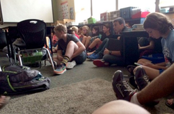 A group of children at the school, hiding in a classroom