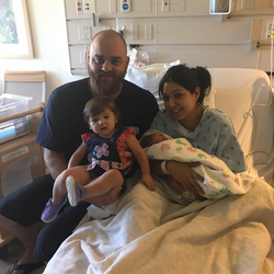 Rocio Garcia with her fiancé Chris Jaksha, her daughter, and her newborn baby in the hospital room (circa August 2017)