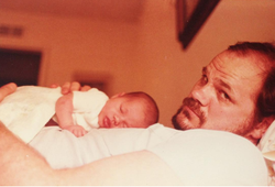 Thomas Markle Sr. with baby, Meghan Markle, on his tummy.