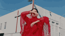 Gif of Rosalia from the music video for the song, "De Plata".