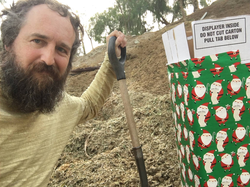 Photo of Robert Strong filling the box with manure