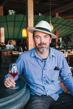 Charlie Hallowell has a glass of wine, looking dapper.