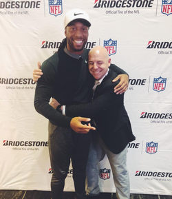 Photo of Anthony Capitano with Larry Fitzgerald.