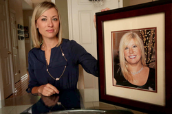 Photo of April Kauffman's daughter, Kim Pack, holding a frame of her mother.