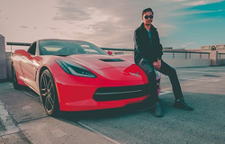 Anish photographed sitting on his Corvette