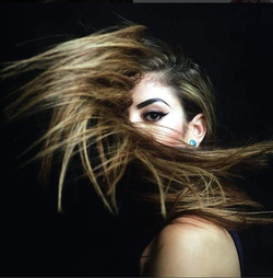 Professional photo of Sara Zghoul with her hair across her face.
