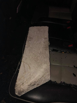 Photo of the concrete curb piece Melissa Shelton allegedly used to damage Jason and Victoria Chapa's 2008 Lincoln MKX.