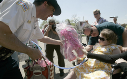 Lt. Paul Bauer presents several gifts to Kira Mammoser, 11, including a pink pony on behalf of the Police Mounted Unit in this May 2013 photo.