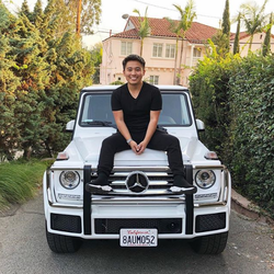 Stephen Liao sitting on a Mercedes