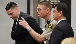 Richard Fischer being taken into custody by a court bailiff after his arraignment