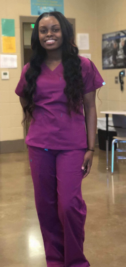 Courtlin La’Shawn in nursing scrubs