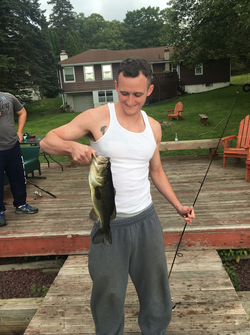 Photo of Daniel Mooney catching a fish.