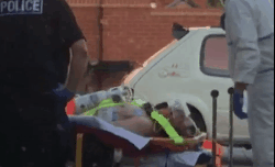 Charlie Rowley getting carried into an ambulance by police and paramedics in hazmat suits