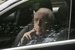 Charles Hallinan peers through reflections on his closed car window after he was sentenced on July 6, 2018 to 14 years in federal prison.