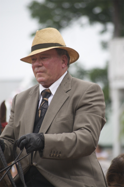 Shatner on a horse, wearing saddle seat attire at a horse show in 2011