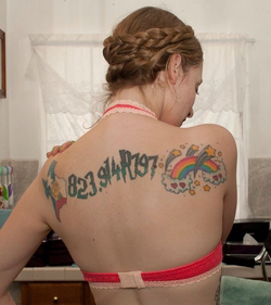 Ela Darling's tattoos on her back include the state of Texas, the Dewey Decimal and Cutter number for Harry Potter and the Philosopher's Stone, and a collection of stars and hearts surrounding a rainbow