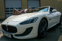 Photo of Roxana Vancea modeling on top of a Maserati.