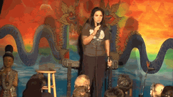GIF of Anica Cihlaperforming Standup comedy.