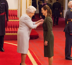 Cohen being decorated as a distinguished member of the Royal Victorian Order by Queen Elizabeth II.