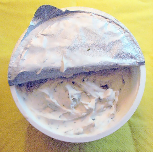 Open package of a soy-based cream cheese alternative with chives