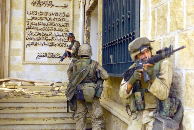 U.S. Marines from 1st Battalion 7th Marines enter a palace during the Fall of Baghdad.