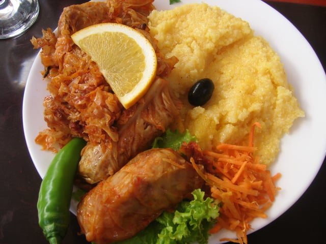 A popular Moldovan dish of stuffed cabbage rolls (sarma), accompanied by sauerkraut and mămăligă.