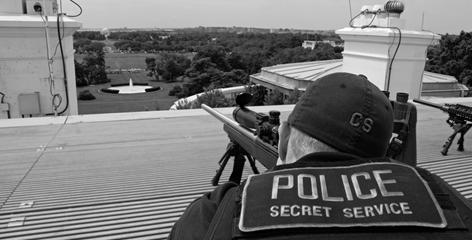 Secret Service counter-sniper marksman on top of the White House's roof, armed with a sniper rifle