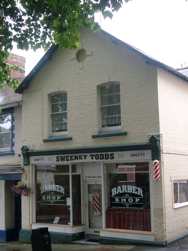 Barber shop in Torquay, Devon, England, with red and white pole