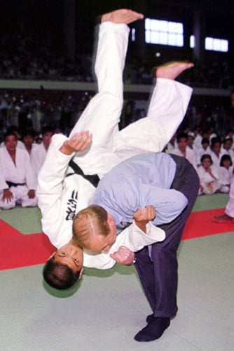 Putin practises judo with a student during a visit to Japan, at the G8 summit