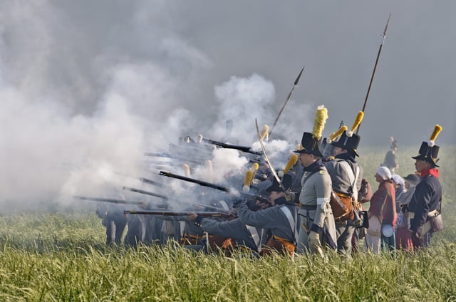 Men in period costume portraying soldiers during a 2011 reenactment of the Battle of Waterloo (1815)