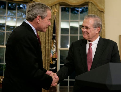 Rumsfeld shakes President Bush's hand as he announces his resignation, November 8, 2006.