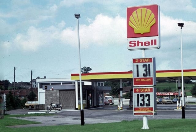 A Shell petrol station selling 2and 4 (leaded petrol) by the gallon in the UK c. 1980