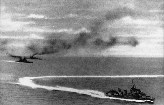 HMS Prince of Wales (left, front) and HMS Repulse (left, rear) under attack by Japanese aircraft. A destroyer is in the foreground.