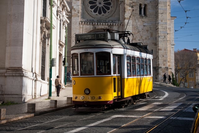 A Lisbon tram by Lisbon Cathedral and Santo António Church.