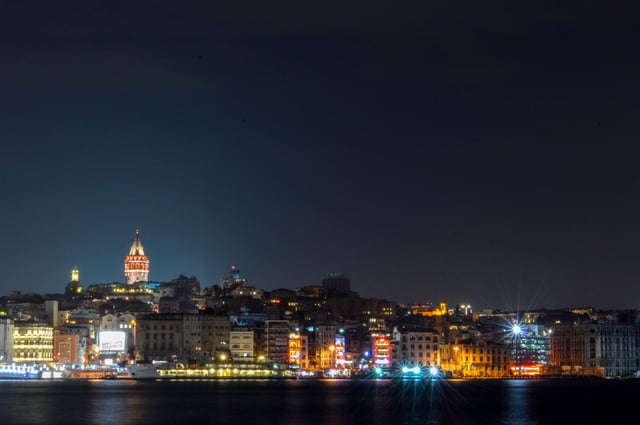 The Karaköy skyline viewed at night, with the illuminated Galata Tower in the background