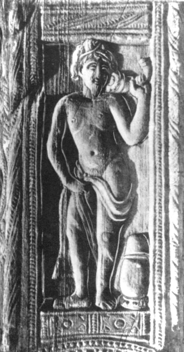 Relief of Dionysus, Nagarjunakonda, Southern India, 3rd century CE. He has a light beard, is semi-nude and carries a drinking horn. There is a barrel of wine next to him.