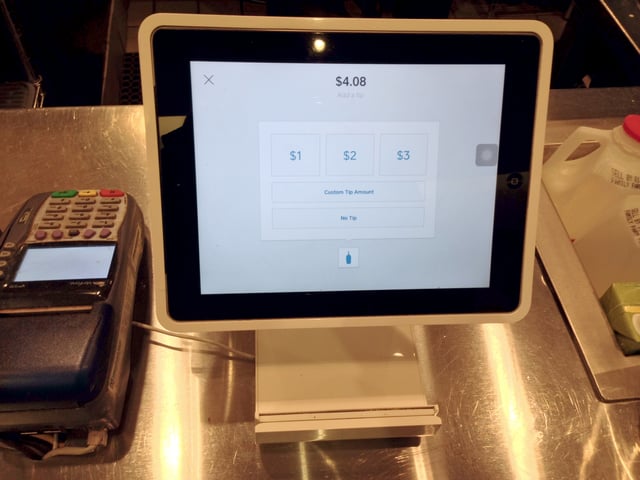 Square Stand at a coffee shop turned around for the customer to choose a tipping option
