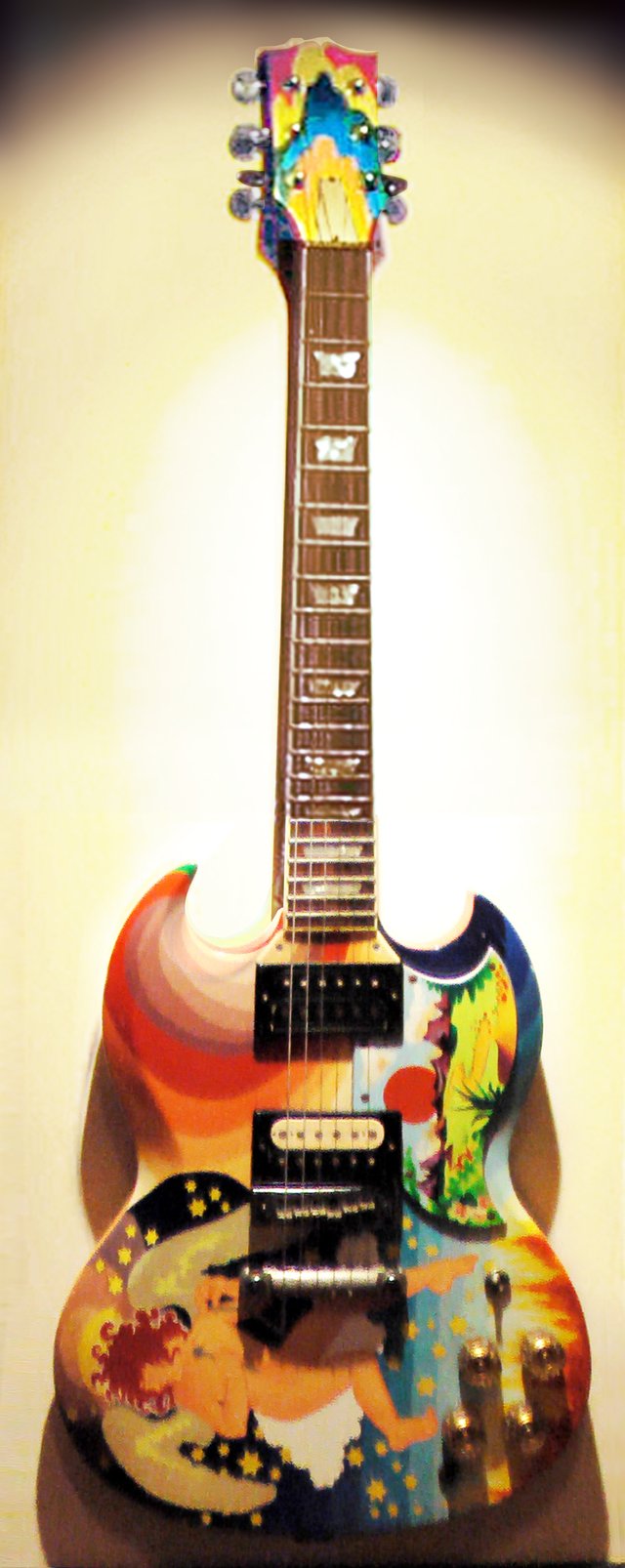 Clapton's The Fool guitar (replica shown), with its bright artwork and famous "woman tone", was symbolic of the 1960s psychedelic rock era.